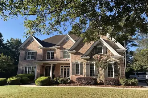 Two-story brick and stone home with shutters in North Georgia