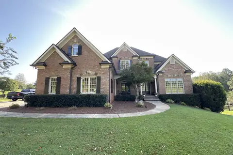 Brick traditional two-story with dark shutters in North Georgia