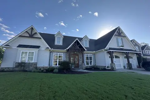Craftsman-style home with stone accents and timber gables in North Georgia